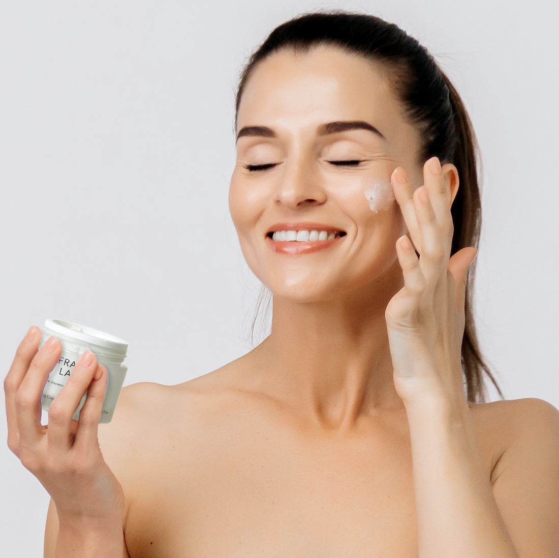 Woman applying luxurious anti-aging face cream for radiant, youthful skin – gentle skincare routine for all skin types